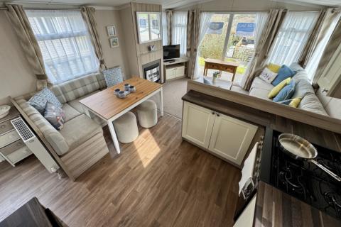 Interior view of the open plan kitchen and dining area with table and bench seating.