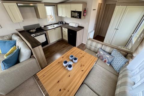Interior view of the dining space with adjacent kitchen. 