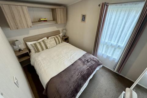 Interior of Master bedroom with double bed and over bed storage. 