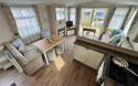 Interior view of the open plan kitchen and dining area with table and bench seating.