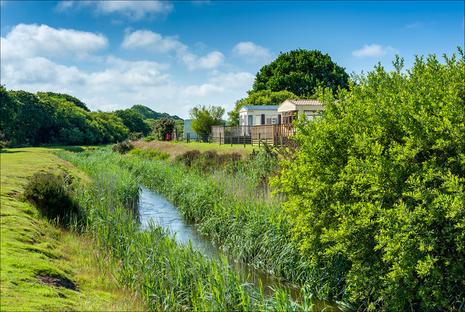 A Stream running through a lush green Countryside setting with Holiday Homes in Cornwall