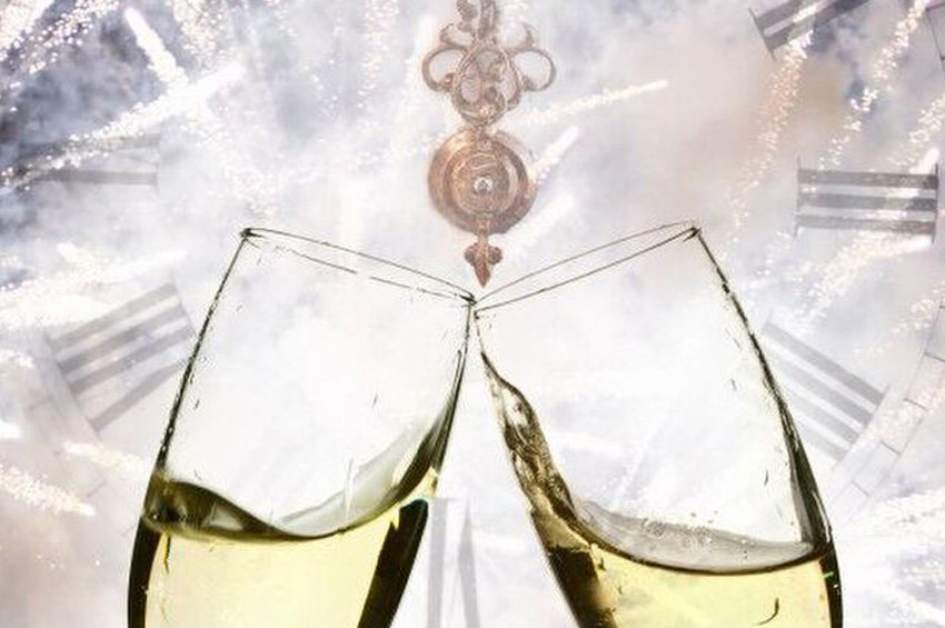 Champagne Glasses with Night Time Fireworks in the Background