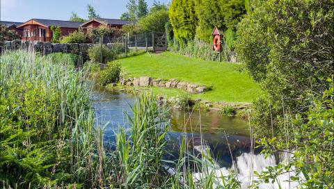 A River running alongside Lodges & Bridge