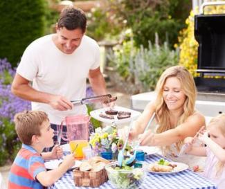 People eating Food around a Outdoor Table