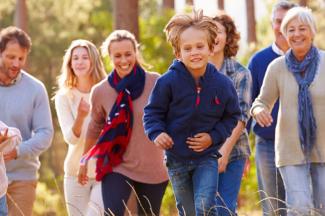 Group of People running through Wooded area