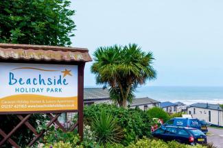 Holiday Park Sign & Holiday Homes with Sea in the Background
