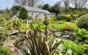 Outdoor View of Cottage in Beautiful Gardens