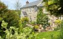 Outdoor View of Cottage in Beautiful Gardens