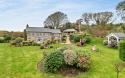 Outdoor View of Cottage in Beautiful Gardens