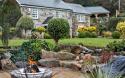 Outdoor View of Cottage in Beautiful Gardens Featuring outdoor Fireplace