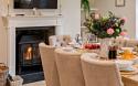 Dining Area in a Holiday Home Featuring a Log Burner