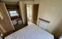 View of master bedroom with door to en-suite bathroom.