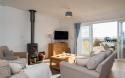 Outside View of a Holiday Home taken from Living area including Outdoor Dinning area and Sea Views