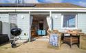 Outside View of a Holiday Home with a Decking area and Dining Table & Chairs