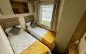 Twin bedroom with two single beds, in-build wardrobes.