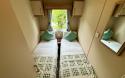 Twin bedroom with two single beds, in-build wardrobes.