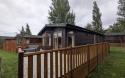 Exterior of a static caravan with a wooden decking.