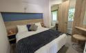 Master bedroom with double bed and a vanity table and stool. 